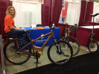 Optibike SIMBB Motor in a hand built wooden bike frame, displayed at The National Hand Built Bicycle Show, and built by Professor Jay Kinsinger at Cederville University