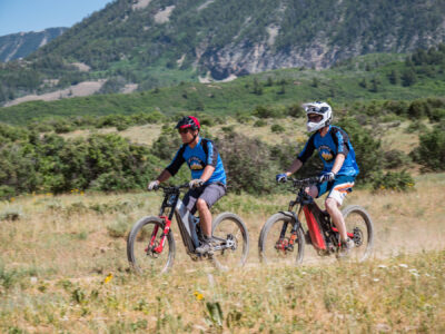 Optibike R17 E-Bikes riding together on a dirt trail