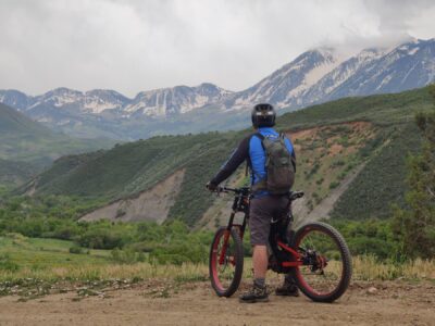 A person on an Optibike looking out at snowy mountain peaks