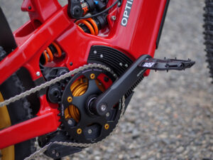 Red mountain bike crankset and suspension close-up