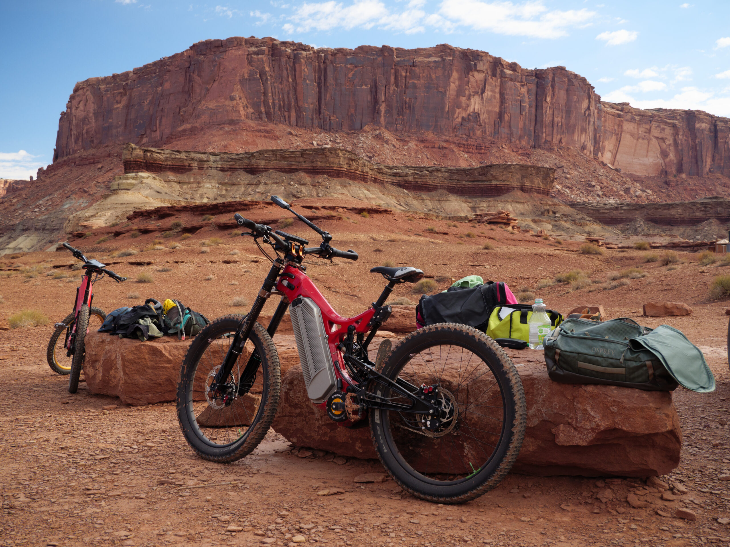 Electric mountain bikes and gear in desert canyon