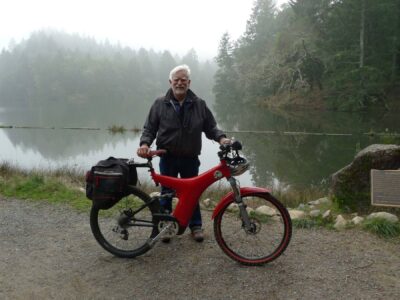Rodger Jacobsen with his Optibike R8 in front of a foggy lake